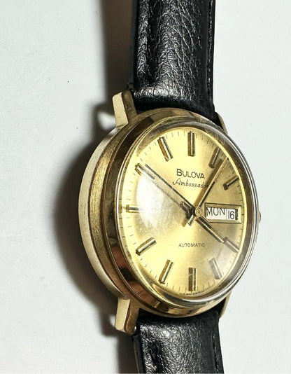 Bulova plated automatic watch with a sleek design, weighing 44.9g, displayed on a neutral background.