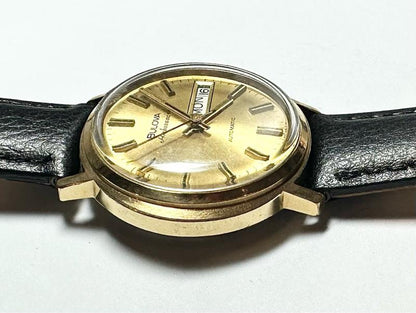 Bulova plated automatic watch with a sleek design, weighing 44.9g, featuring a polished metal finish and classic watch face.