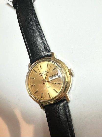 Bulova plated automatic watch with a sleek design, weighing 44.9 grams, showcasing its elegant dial and metal bracelet.