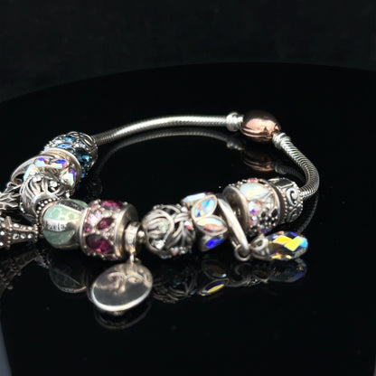 925 silver Chamilia charm bracelet featuring intricate charms on a sleek bracelet band.