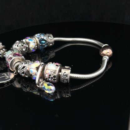 925 silver Chamilia charm bracelet with engraved charms, featuring a sleek design and secure clasp for stylish wear.