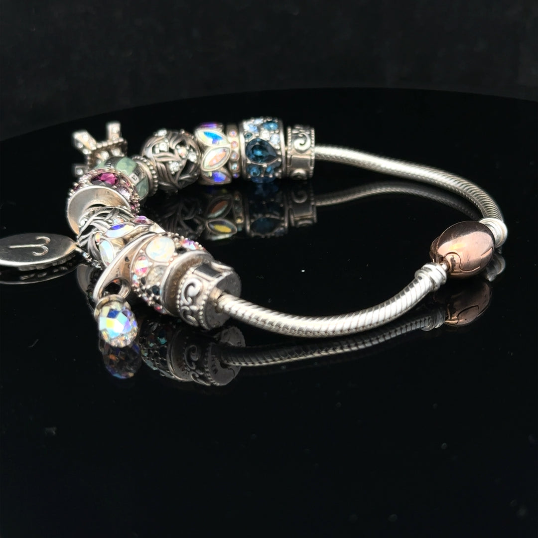 925 silver Chamilia charm bracelet featuring intricate designs and a secure clasp, crafted for elegant wear.
