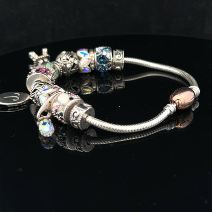 925 silver Chamilia charm bracelet featuring intricate designs and a secure clasp, crafted for elegant wear.