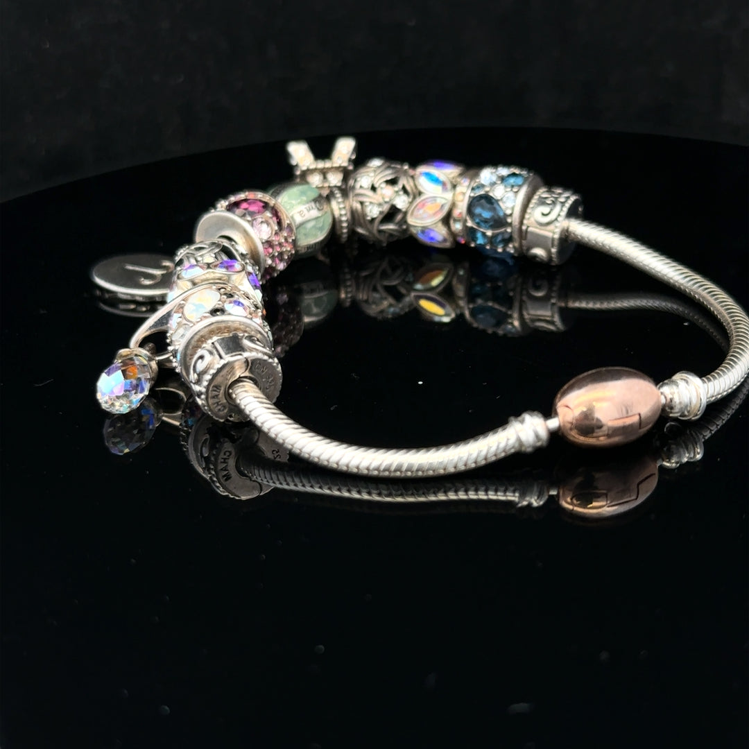 Silver Chamilia charm bracelet featuring detailed charms and secure clasp, crafted from 925 sterling silver.
