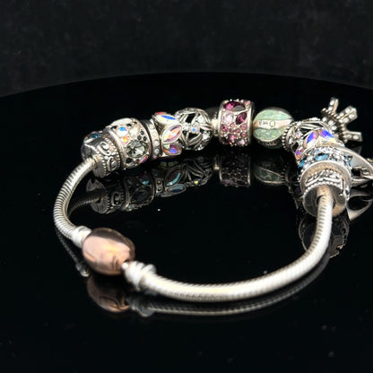 925 silver Chamilia charm bracelet featuring intricate designs and clasp, showcasing elegant jewelry craftsmanship.