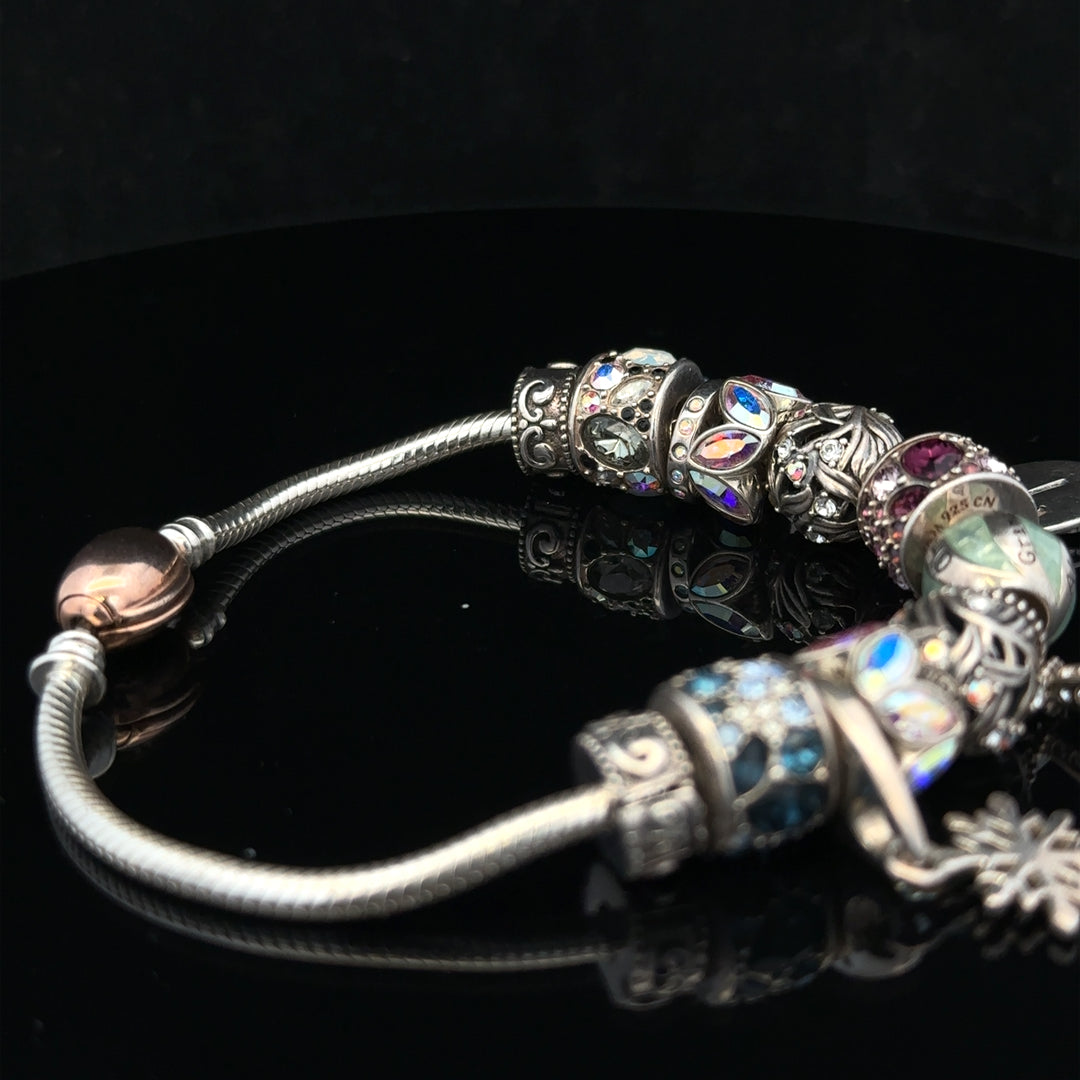 925 silver Chamilia charm bracelet featuring intricate charms and a secure clasp, designed for stylish accessory wear.