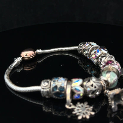 925 silver Chamilia charm bracelet with intricate charms, featuring a sleek design and polished finish.
