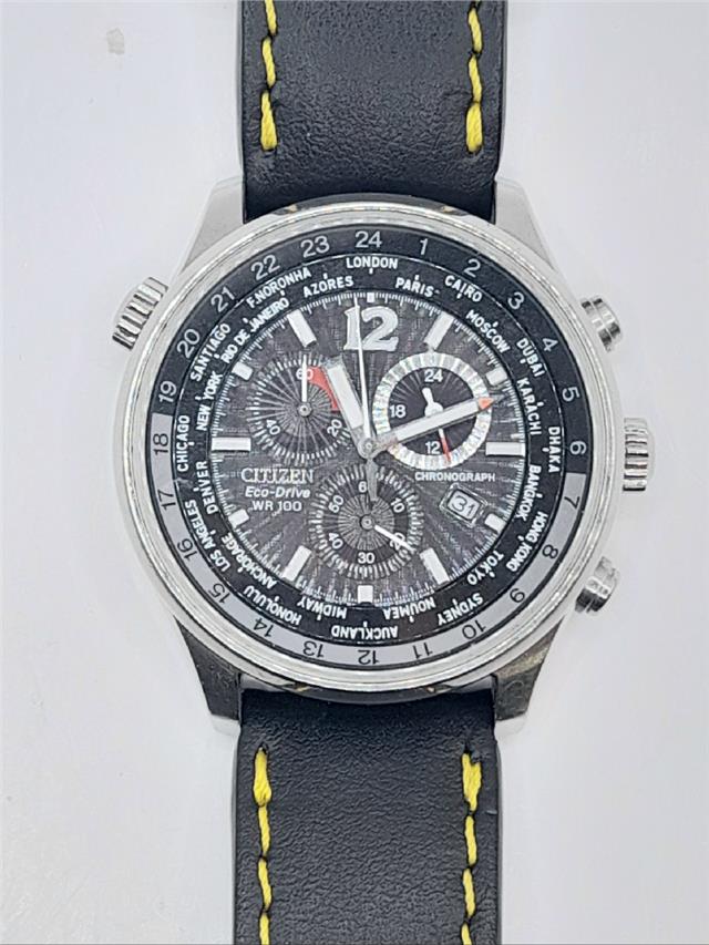 Citizen WR100 Eco-Drive watch model SH24922B with black dial and stainless steel band, displaying time and date.