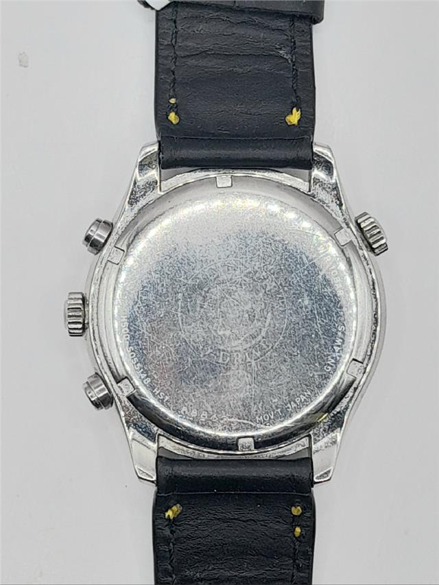 Citizen WR100 Eco-Drive watch with stainless steel band and black dial, displaying time and date on the watch face.