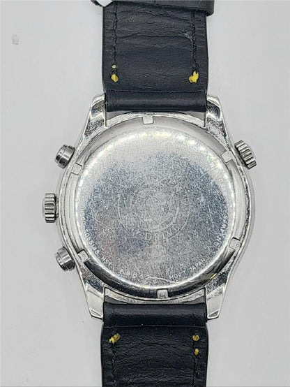 Citizen WR100 Eco-Drive watch with stainless steel band and black dial, displaying time and date on the watch face.