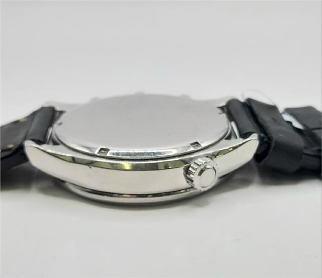 Citizen WR100 Eco-Drive watch with black strap and silver dial, showcasing sleek design and durable construction.