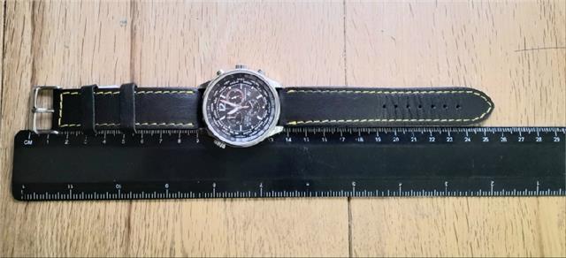 Citizen WR100 Eco-Drive watch with black dial and stainless steel band, showcasing durable and stylish timepiece design.