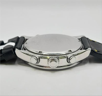 Citizen WR100 Eco-Drive watch with black dial and stainless steel band, showcasing a sleek, modern design.