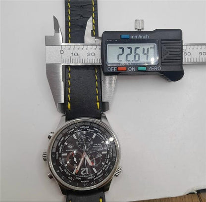 Citizen WR100 Eco-Drive watch with black dial and stainless steel band, showing time and date on the watch face.