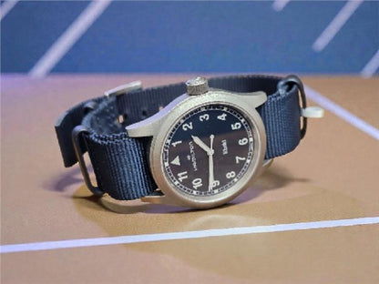 Hamilton Khaki watch Age 2025 with black dial, stainless steel case, and leather strap, showcasing a classic, military-inspired design.