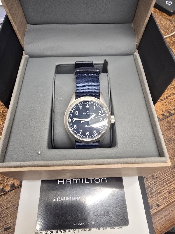 Hamilton Khaki watch Age 2025, men's wristwatch with black dial, stainless steel case, and NATO strap.
