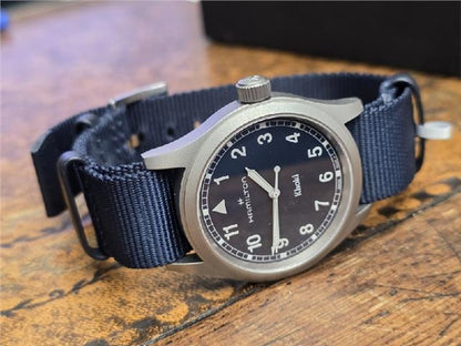Hamilton Khaki watch Age 2025 with stainless steel case, black dial, and leather strap, displayed on a white background.