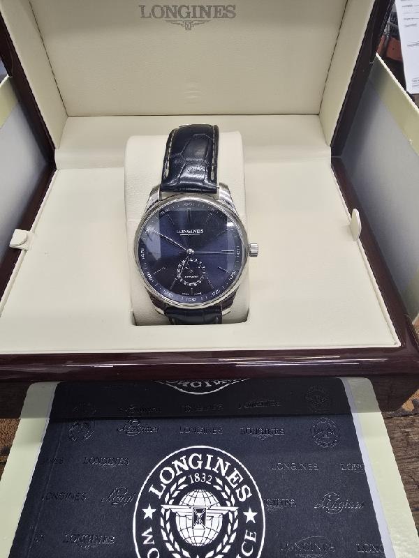 Longines Master Collection watch with boxed papers, featuring a classic design and stainless steel case.