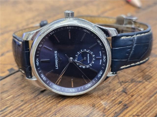 Longines Master Collection watch with boxed papers, featuring a classic design and stainless steel bracelet.