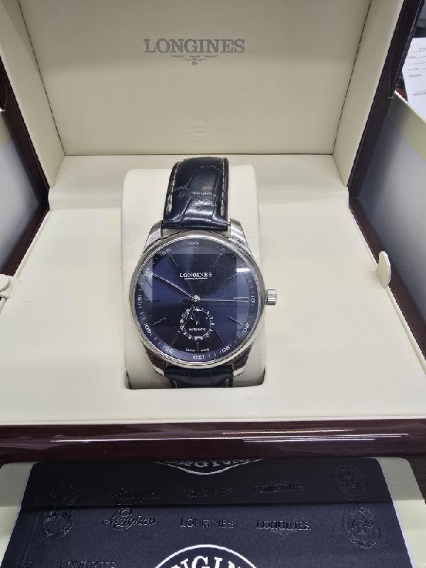 Longines Master Collection watch with boxed papers, featuring a classic design and stainless steel case.