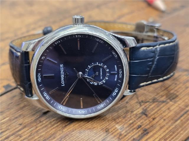 Longines Master Collection watch with boxed papers, showcasing a classic design and stainless steel case.