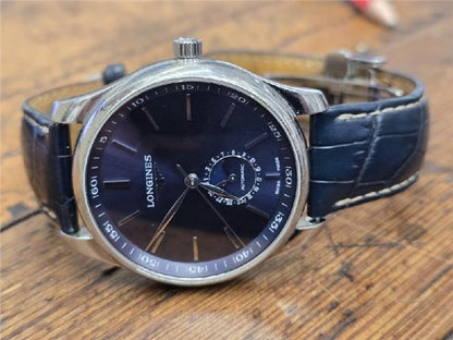 Longines Master Collection watch with boxed papers, showcasing a classic design and stainless steel case.