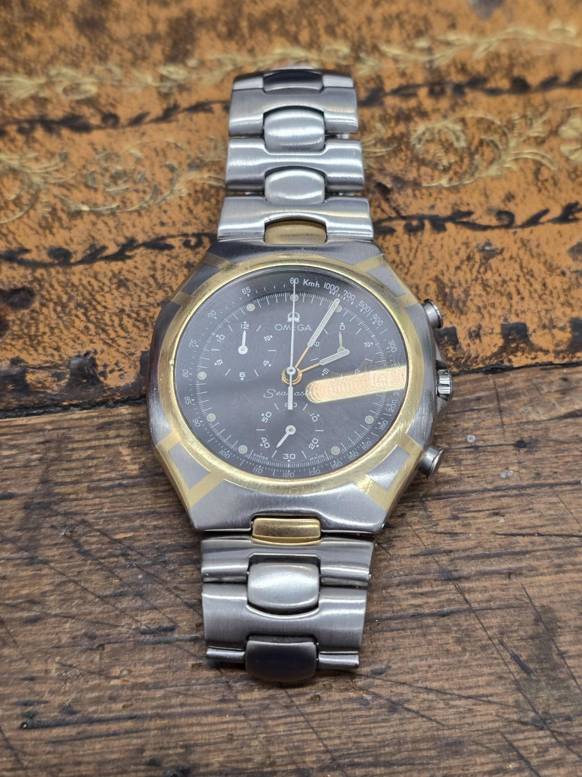 Omega Seamaster Polaris Chronograph watch with box and card, showcasing the stainless steel case and black dial.