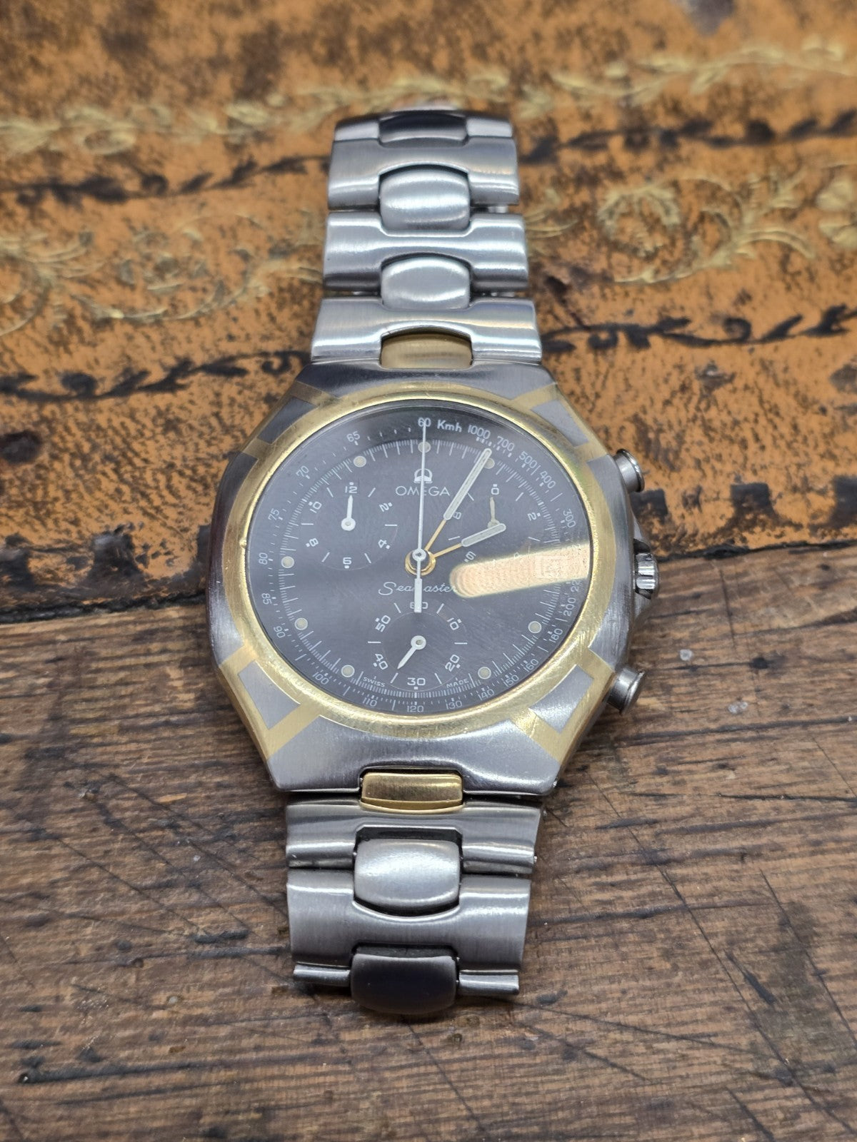 Omega Seamaster Polaris Chronograph watch with box and card, featuring a stainless steel case and black dial.