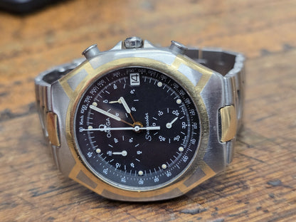 Omega Seamaster Polaris Chronograph watch with box and card, featuring a stainless steel case and black dial.