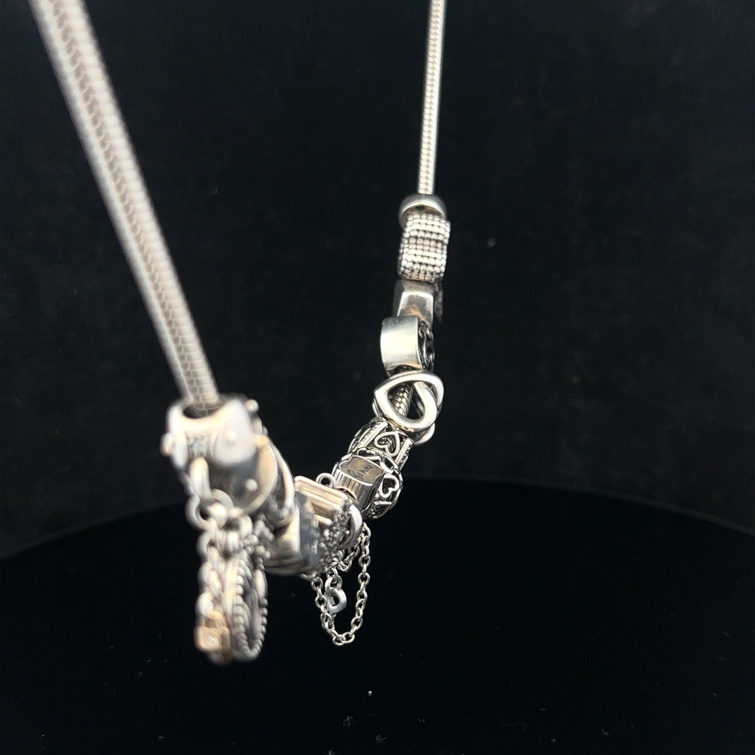 Pandora charm necklace, 20-inch chain with intricate design, crafted by PANDORA, shown in a close-up image.