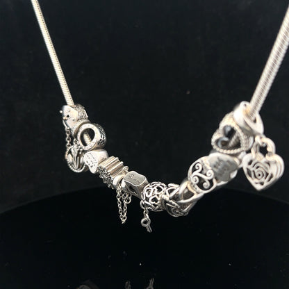 Pandora charm necklace, 20-inch chain, silver-tone jewelry with intricate design and clasp, showcasing elegant craftsmanship.