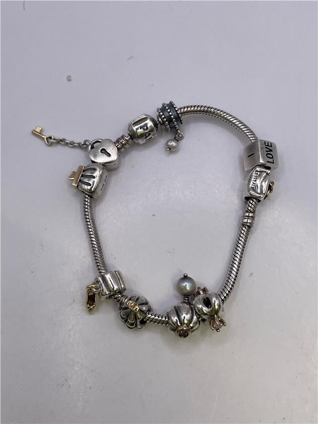 Silver Pandora bracelet with intricate design, weighing 42.3 grams, showcasing its elegant craftsmanship.