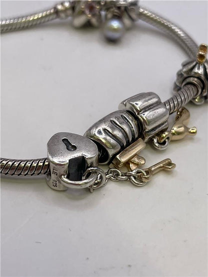Silver Pandora bracelet with intricate design, weighing 42.3 grams, featuring detailed craftsmanship and a polished finish.