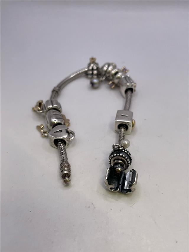 Silver Pandora bracelet with intricate design, featuring a 42.3g weight and detailed craftsmanship, showcasing the Pandora brand.
