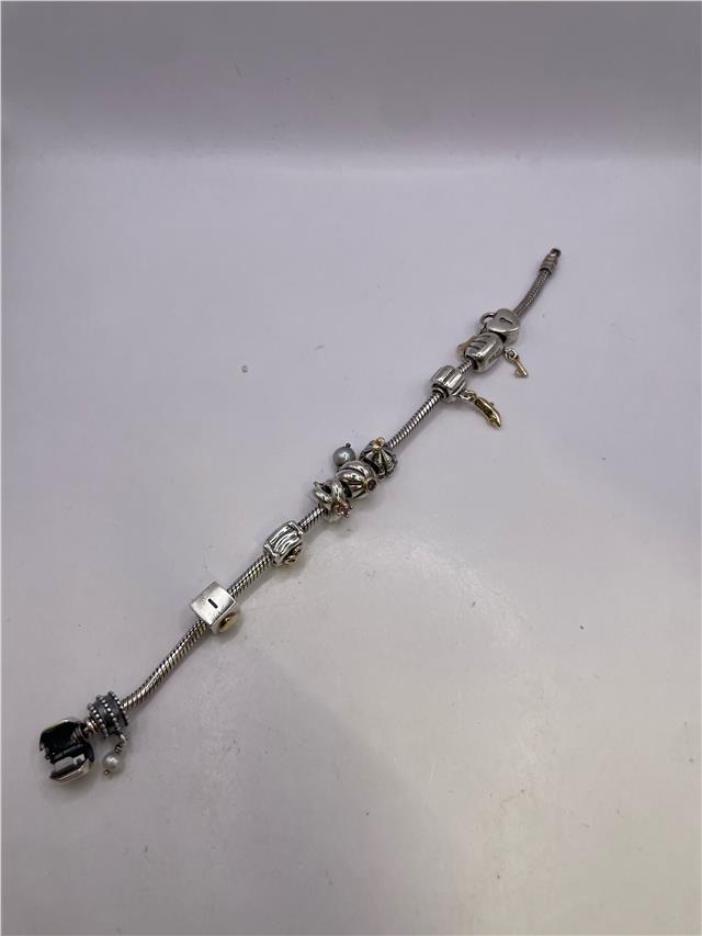 Silver Pandora bracelet with intricate design, featuring a lightweight chain and clasp, weighing 42.3 grams.