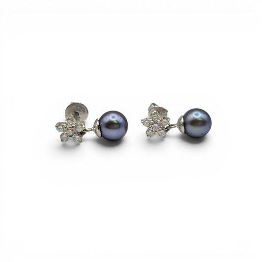 Reeves and Sons 18ct white gold diamond and pearl earrings with elegant drop design on a white background.