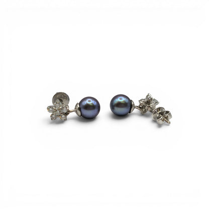 18ct white gold diamond and pearl earrings by Reeves and Sons, featuring elegant pearl drops with sparkling diamonds.