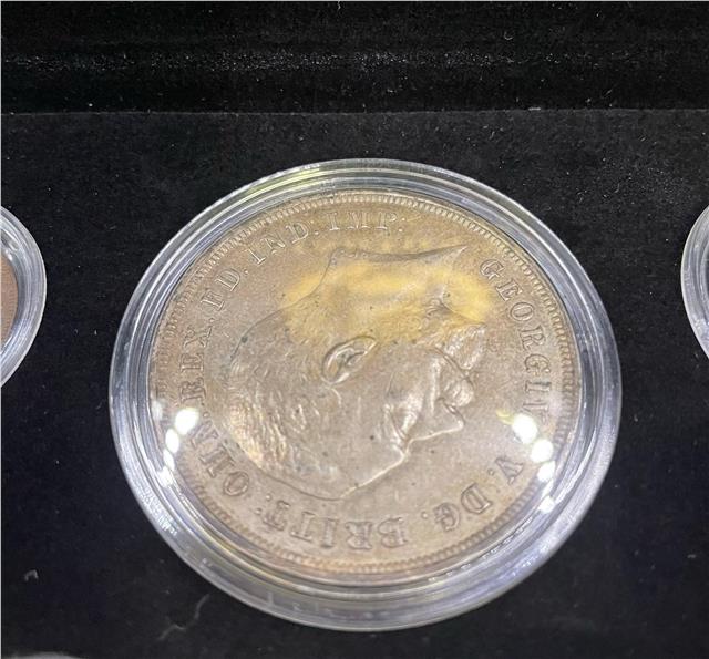 1935 Silver Jubilee silver coin set by Reeves and Sons, featuring commemorative coins with detailed engravings.