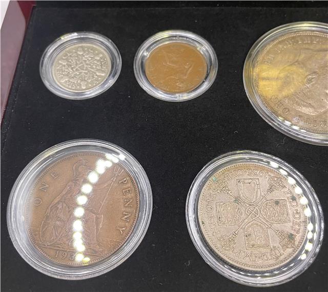 Reeves and Sons 1935 Silver Jubilee set silver coins, detailed design, commemorative coin collection in a display case.
