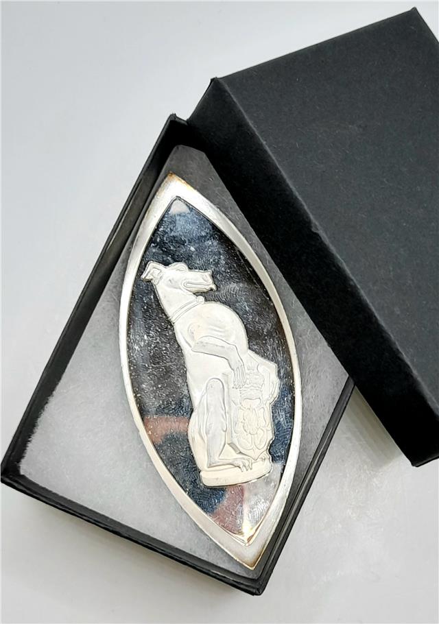 Reeves and Sons Queen's Beasts silver coin ingot with intricate design, shiny silver surface, and detailed engravings.