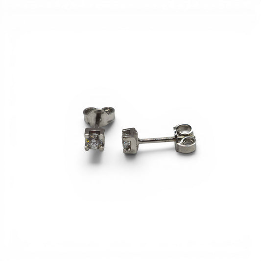 18ct white gold diamond stud earrings by Reeves and Sons, showcasing sparkling diamonds set in elegant gold.