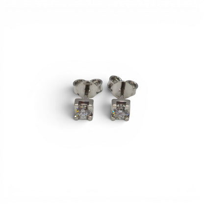 18ct white gold diamond stud earrings by Reeves and Sons, featuring sparkling diamonds in a classic design.