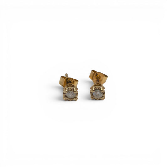 Pair of 9ct yellow gold diamond stud earrings by Reeves and Sons, featuring round-cut diamonds on classic gold settings.