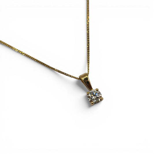 Reeves and Sons 9ct yellow gold chain with 0.25 carat diamond pendant, showcasing a delicate gold chain and sparkling diamond.