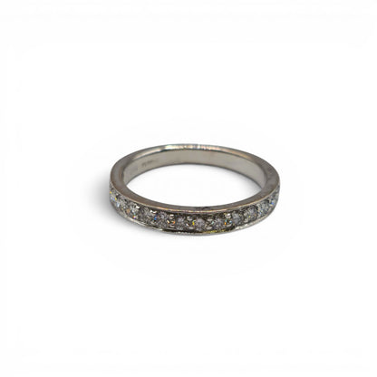 18ct white gold half eternity diamond ring by Reeves and Sons featuring sparkling diamonds in a sleek band design.