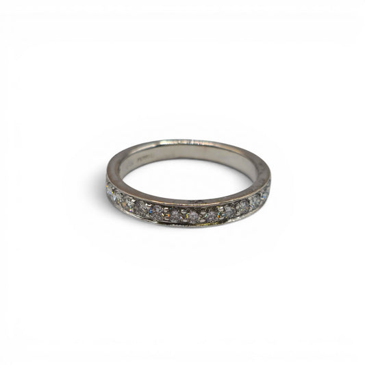 18ct white gold half eternity diamond ring by Reeves and Sons featuring sparkling diamonds in a sleek band design.