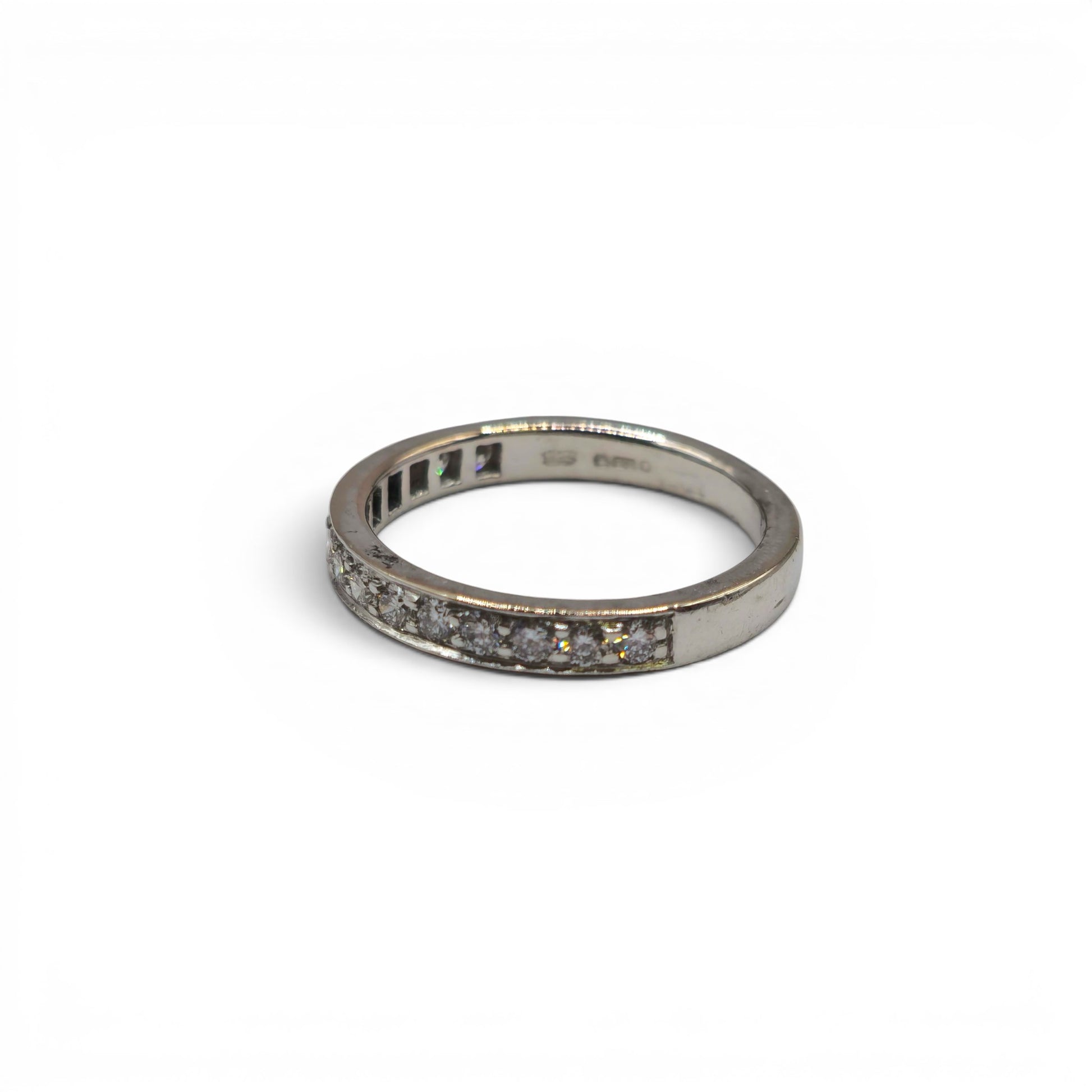 18ct white gold half eternity diamond ring by Reeves and Sons, featuring a row of sparkling diamonds in a sleek band.