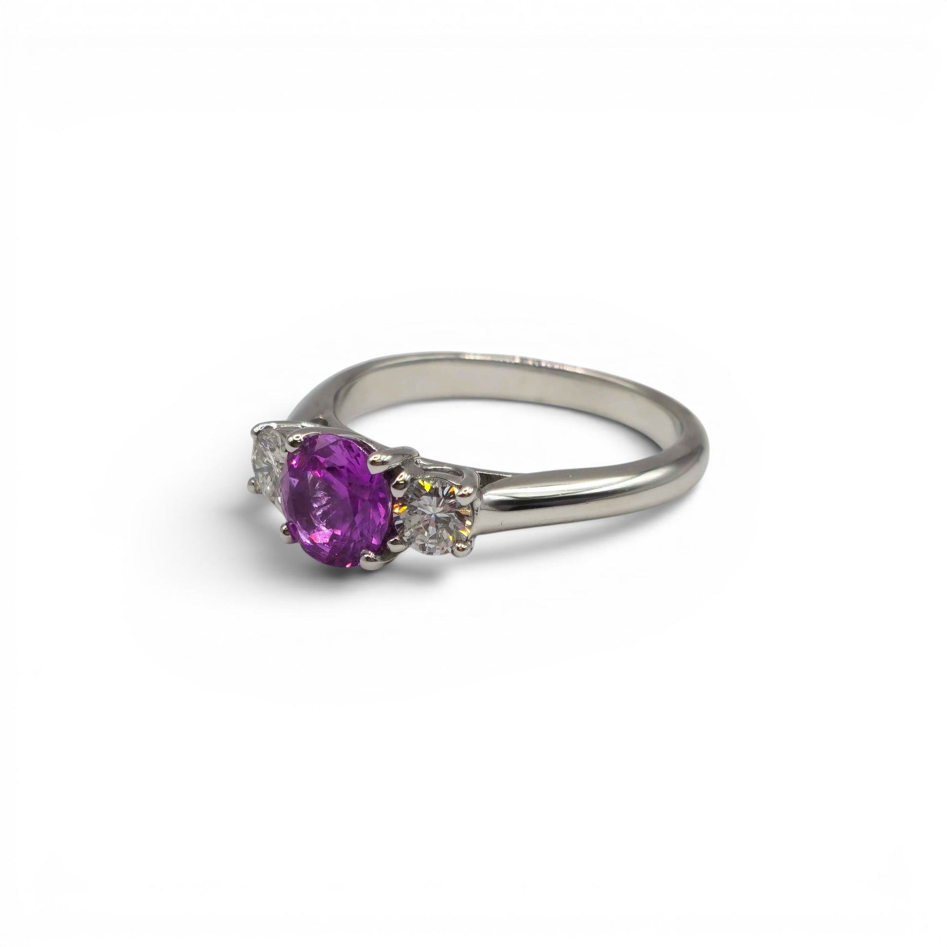 18ct white gold pink sapphire and diamond ring by Reeves and Sons, featuring a central pink sapphire with diamond accents.