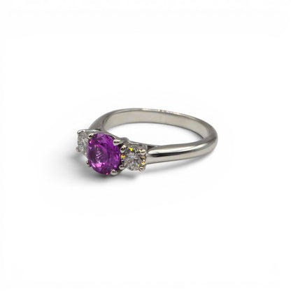 18ct white gold pink sapphire and diamond ring by Reeves and Sons, featuring a central pink sapphire with diamond accents.