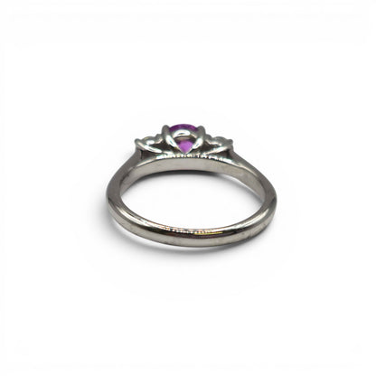 18ct white gold pink sapphire and diamond ring by Reeves and Sons, featuring a pink sapphire centerpiece with diamond accents.